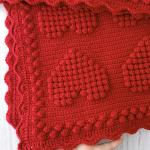 Hand-knitted baby blanket with heart pattern, red and embossed 💕