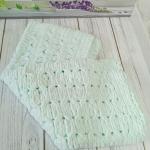 Patterned baby blanket made with knitted and plush (puffy) yarn