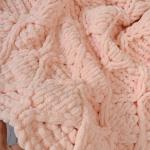 Patterned baby blanket made with knitted and plush (puffy) yarn