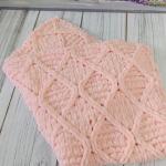 Patterned baby blanket made with knitted and plush (puffy) yarn