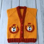 Hand-knitted, lion-themed, yellow and red baby cardigan