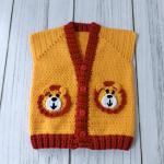 Hand-knitted, lion-themed, yellow and red baby cardigan