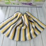 Hand-knitted baby blanket - embossed pattern in yellow, white and anthracite colors.