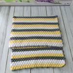 Hand-knitted baby blanket - embossed pattern in yellow, white and anthracite colors.