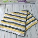 Hand-knitted baby blanket - embossed pattern in yellow, white and anthracite colors.